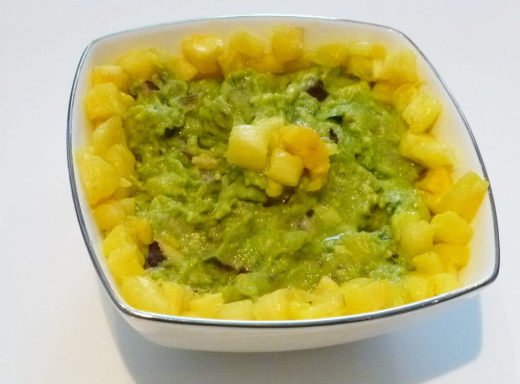 Pineapple Guacamole -- Give your guacamole a boost of tropical fresh flavour. With avocados, pineapple, red onions, lime juice and cilantro, this sweet and savoury guacamole is a real crowd pleaser. | thishappymommy.com
