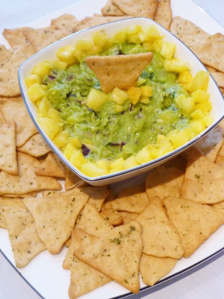 Pineapple Guacamole -- Give your guacamole a boost of tropical fresh flavour. With avocados, pineapple, red onions, lime juice and cilantro, this sweet and savoury guacamole is a real crowd pleaser. | thishappymommy.com