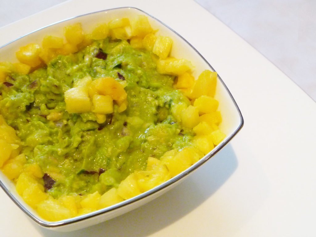 Pineapple Guacamole -- Give your guacamole a boost of tropical fresh flavour. With avocados, pineapple, red onions, lime juice and cilantro, this sweet and savoury guacamole is a real crowd pleaser. | thishappymommy.com