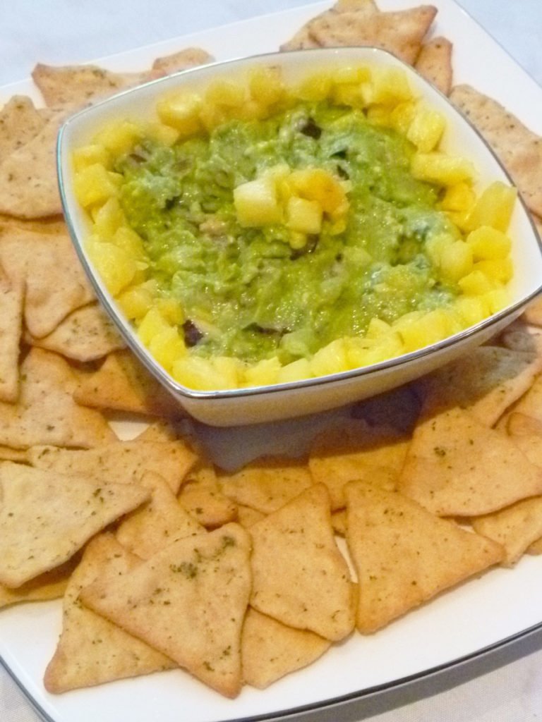 Pineapple Guacamole -- Give your guacamole a boost of tropical fresh flavour. With avocados, pineapple, red onions, lime juice and cilantro, this sweet and savoury guacamole is a real crowd pleaser. | thishappymommy.com