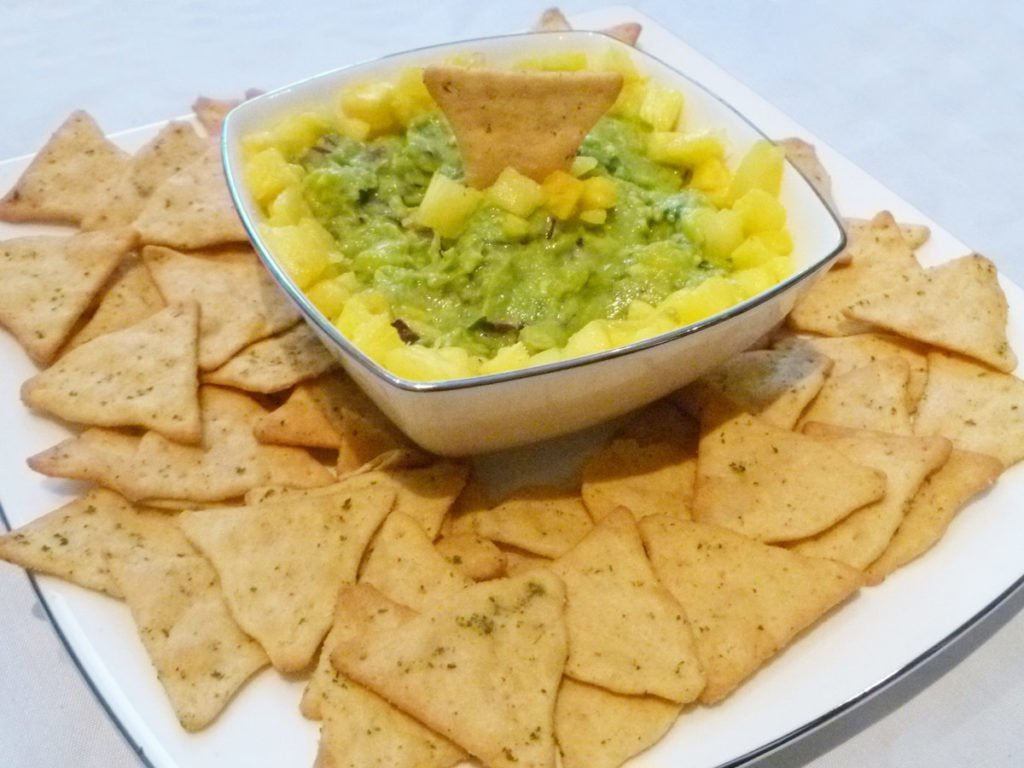 Pineapple Guacamole -- Give your guacamole a boost of tropical fresh flavour. With avocados, pineapple, red onions, lime juice and cilantro, this sweet and savoury guacamole is a real crowd pleaser. | thishappymommy.com