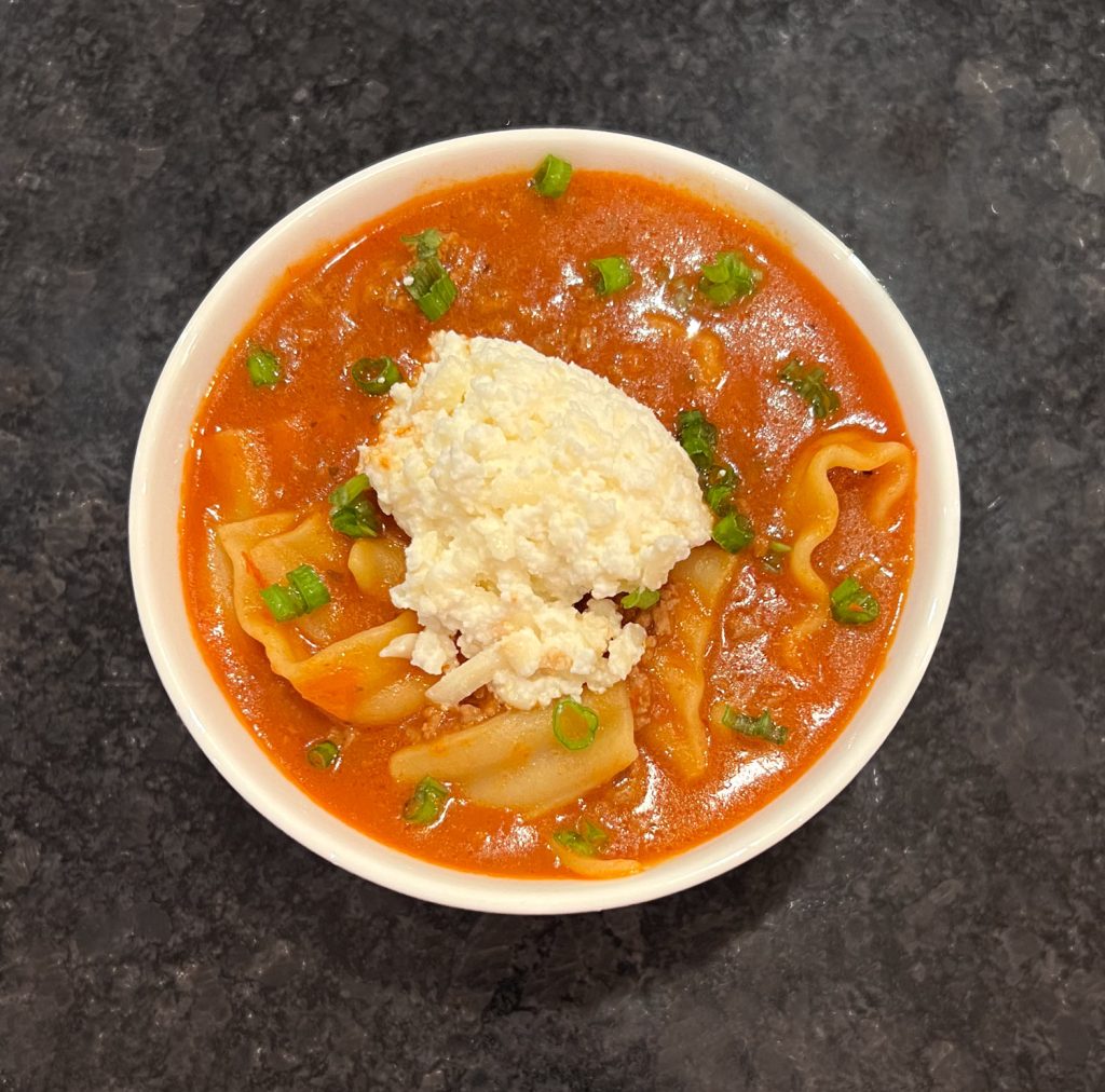 Easy Lasagna Soup is everything you love about lasagna, made easier. Tender pasta, ground beef, and a rich tomato broth simmer together in one pot, then each bowl is finished with ricotta and mozzarella. | thishappymommy.com