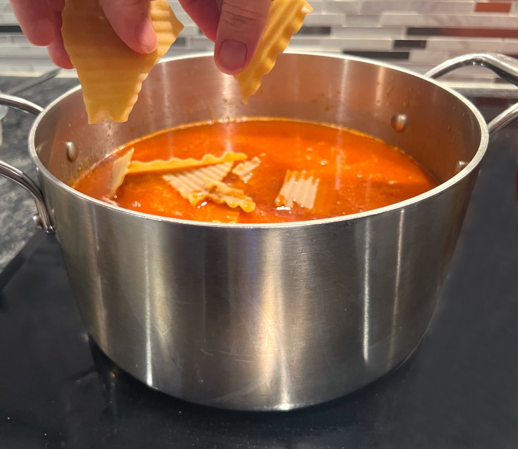 Lasagna Soup - breaking the lasagna noodles and adding them to the pot